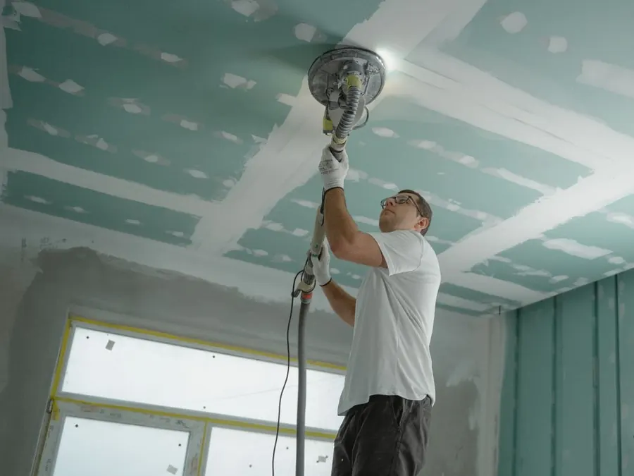 Drywall being sanded and finished