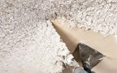 Popcorn ceiling texture being scraped off