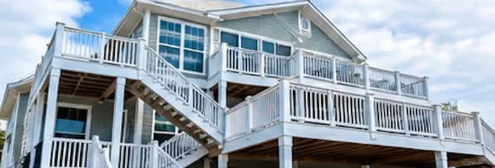 Large coastal home with white railings